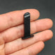 Magazine for the 1:3 1911 Scale Handgun - Black shown held between fingers on a dark background.