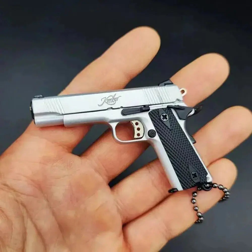 1:3 1911 Scale Handgun - Silver miniature model with die cast metal parts, functional safety, and slide in hand.