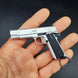 1:3 1911 Scale Handgun - Silver miniature model with die cast metal parts, functional safety, and slide in hand.