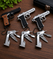 Keychain guns and multi-tools on a wooden surface with a plant in the corner.
