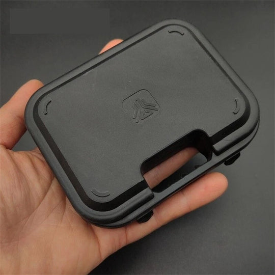 Plastic Suitcase Box for Pistol in black durable plastic held in hand for compact pistol keychain storage and organization.