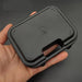 Plastic Suitcase Box for Pistol in black durable plastic held in hand for compact pistol keychain storage and organization.