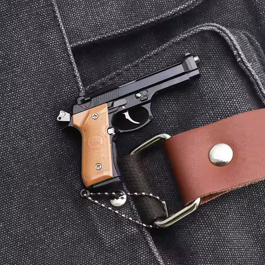 1:3 Beretta 92FS Handgun - Black miniature model with black slide and tan grips shown on fabric background.