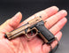 1:3 Beretta 92FS Handgun - Desert Tan miniature model with working safety and slide held in a hand.