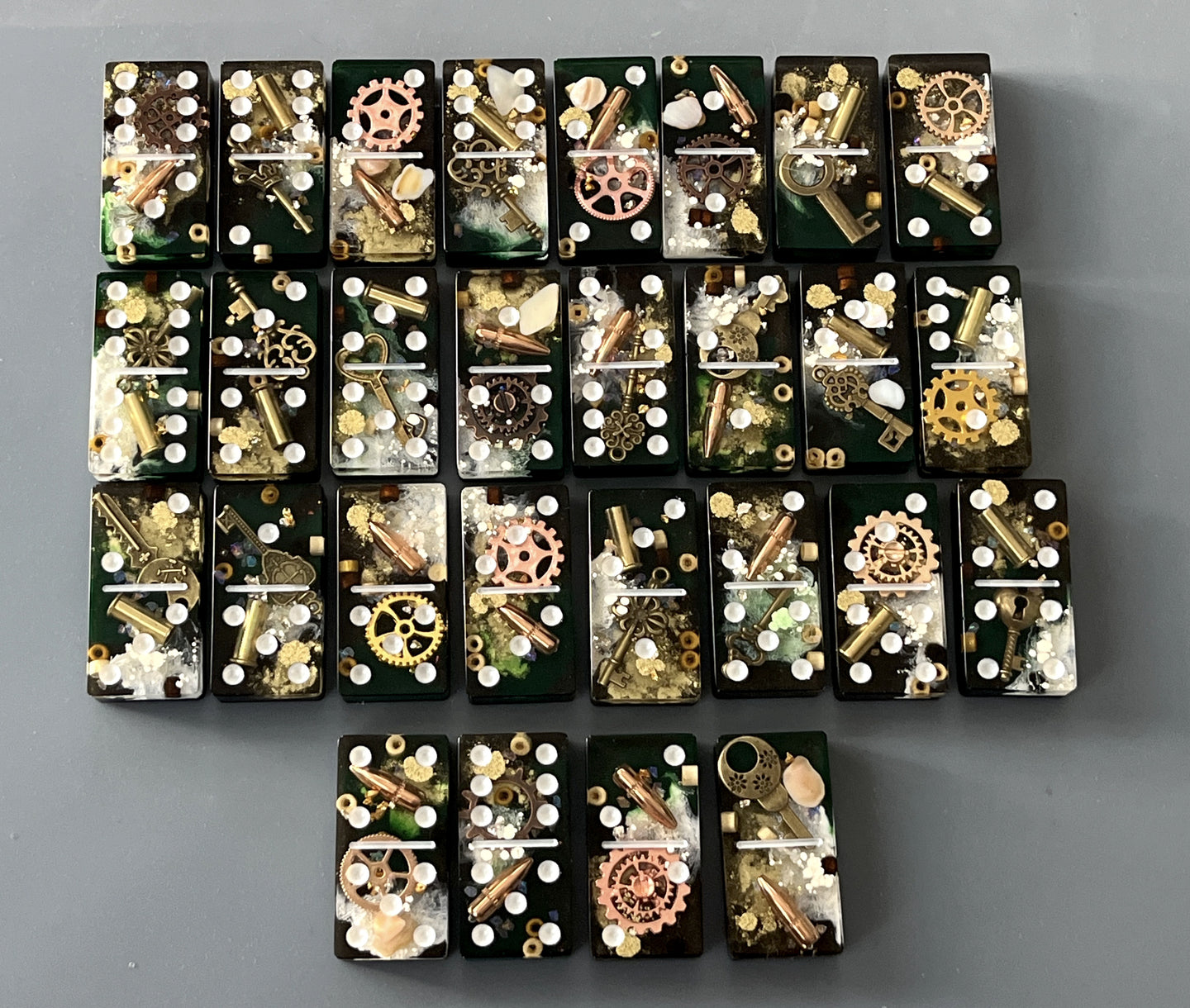 Bullets and Casings Dominos Double 6 Set with unique handmade pieces featuring bullets and gears on black tiles.