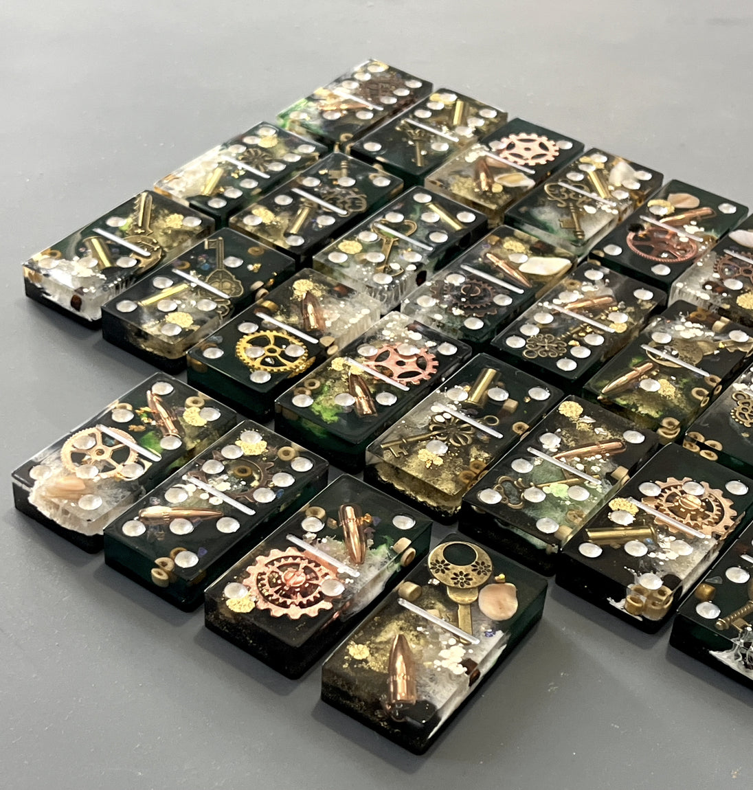 Bullets and Casings Dominos Double 6 Set with unique handmade pieces featuring embedded bullets and gears.