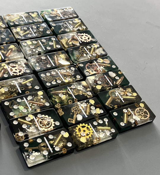 Bullets and Casings Dominos Double 6 Set with handmade resin pieces containing bullets and metal gears.