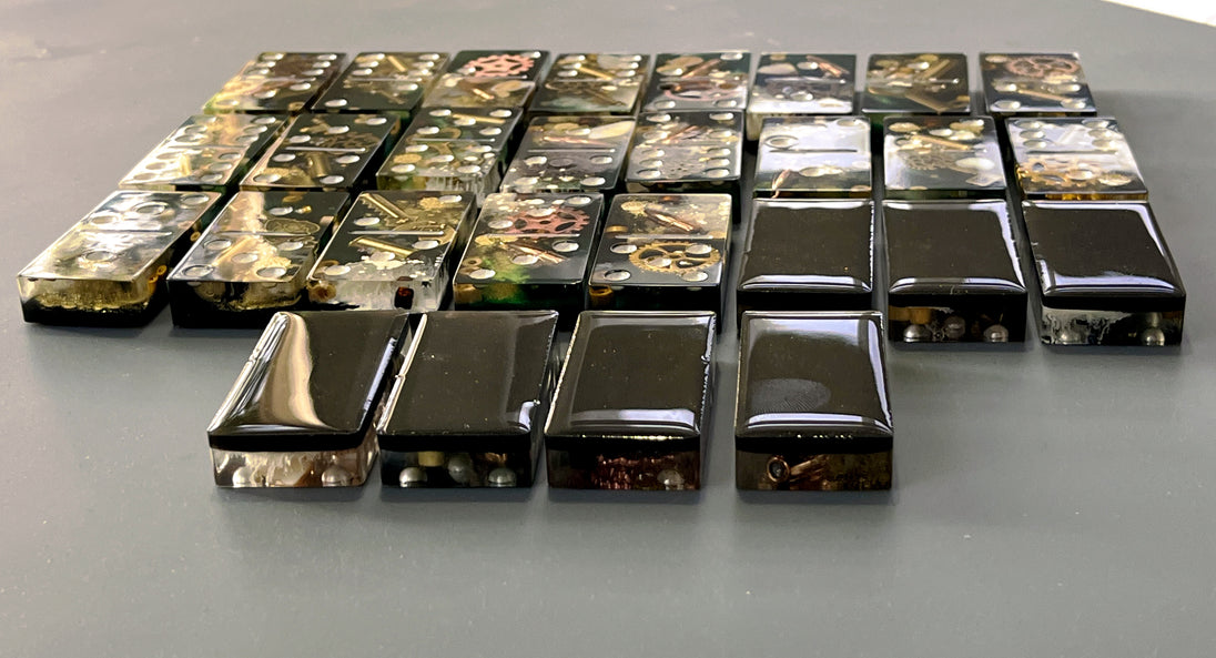Bullets and Casings Dominos Double 6 Set handmade domino pieces with embedded bullet casings arranged on a flat surface.