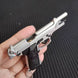1:3 Beretta 92FS Handgun - Silver miniature model with detailed metal parts and black grips shown in hand.