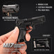 A black toy keychain model pistol held in a hand against a dark background, with feature callouts including 'movable slide,' 'ejectable magazine,' and 'pull-back shell,' plus an inset showing disassembled parts and a shell model.