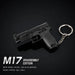 A black disassembled toy gun keychain on a black background, with text reading 'M17 DISASSEMBLY EDITION' and material details below.