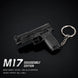 A black disassembled toy gun keychain on a black background, with text reading 'M17 DISASSEMBLY EDITION' and material details below.