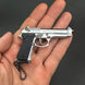 1:3 Beretta 92FS Handgun - Silver miniature model with black grips, die cast metal, realistic details in hand.