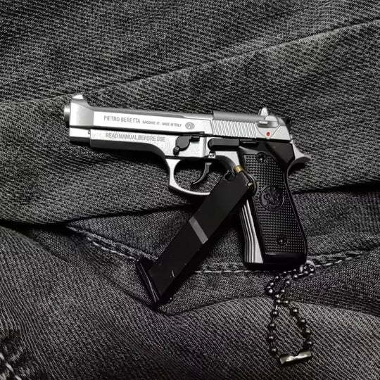 1:3 Beretta 92FS Handgun - Silver miniature model with working slide, safety, and removable magazine on dark fabric background.