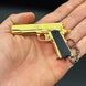 1:3 1911 Scale Handgun - Gold miniature replica with black grips held in a hand, detailed die cast metal parts