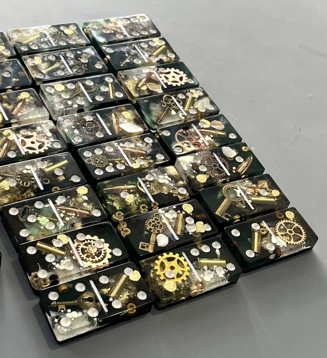Bullets and Casings Dominos Double 6 Set with handmade resin pieces containing bullets and metal gears.
