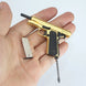 1:3 1911 Scale Handgun - Gold miniature with black grips and detachable magazine held in a hand.