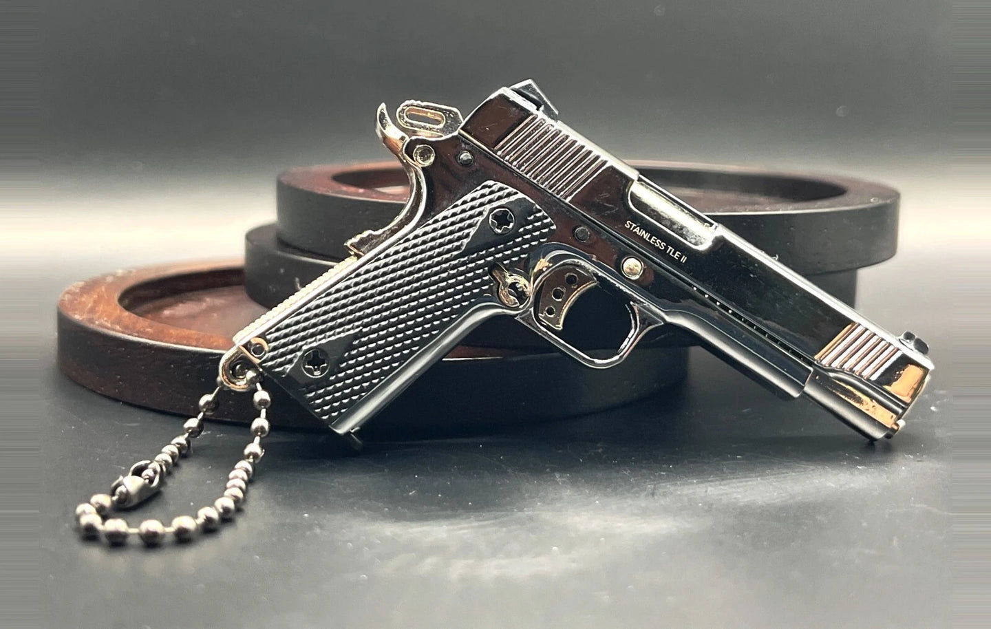 1:3 1911 Scale Handgun - Shiny Silver miniature die cast metal model with black grips and working parts on display.